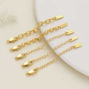 Macro shot of 18K gold-plated necklace extension chains with various lobster clasps