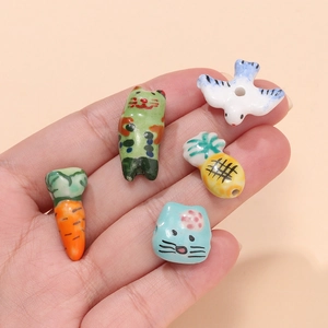 Hand-painted ceramic beads in cat and fruit shapes for DIY jewelry making and crafts