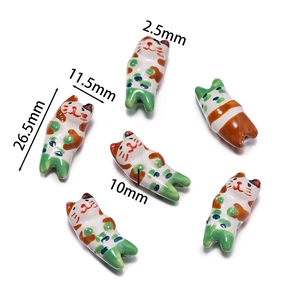 Macro view of hand-painted ceramic cat beads for DIY jewelry with size measurements