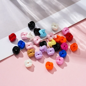 Detail of colorful bow and floral acrylic beads with water ripple lighting for DIY jewelry