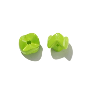Macro shot of green wavy acrylic spacer beads with square holes for DIY jewelry making