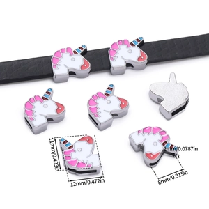 Macro detail of colorful unicorn alloy slider charm on black strap with dimensions