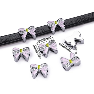 Detail of pink enamel bow charm for DIY bracelets showing 13mm size and dimensions