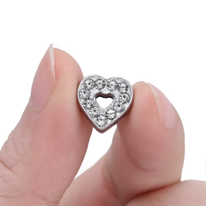 Detailed view of silver hollow heart charm with sparkling rhinestones for DIY jewelry