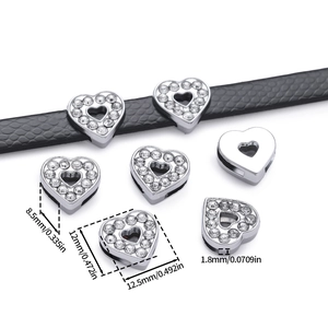 Macro shot of rhinestone heart bead accessory with dimensions shown on black leather belt