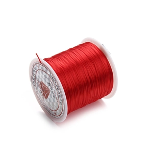 Red elastic crystal string for jewelry making on a white spool for DIY handicraft