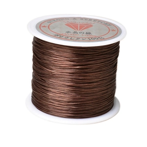 Macro shot of 1mm brown elastic crystal string on spool for DIY jewelry making