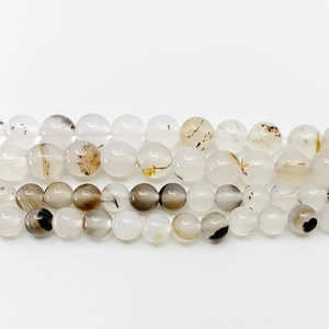 Detailed view of natural pink zebra stone round beads with unique dark inclusions