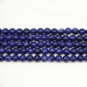 Macro shot of dark blue weathered agate beads with natural stone texture for jewelry making
