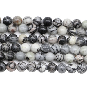 Macro shot of natural agate stone beads with gray and white marble patterns for DIY jewelry