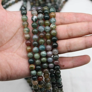 Natural Indian Agate round beads with green moss texture held for DIY jewelry making