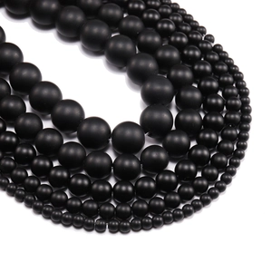 Natural matte black onyx stone beads in various sizes arranged in neat concentric circles