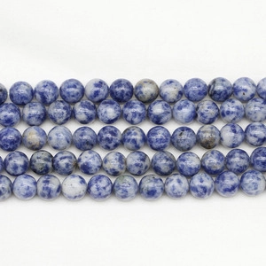 Macro shot of natural blue and white sodalite beads for DIY jewelry bracelet making