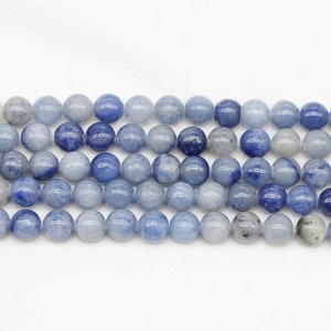 Macro detail of polished natural blue leopard skin stone round beads for DIY jewelry