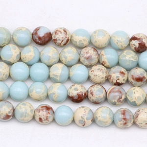 Polished round ocean jasper beads with blue, white and brown marble textures for DIY jewelry