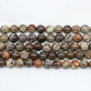 Macro detail of natural Jasper beads with unique brown and cream landscape texture