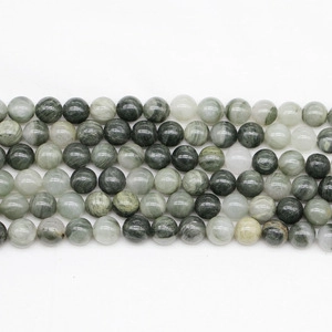 Macro shot of natural green Dragon Blood Jasper round beads with unique stone texture