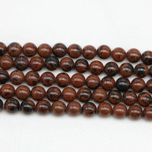 Macro detail of polished Mahogany Obsidian round beads for DIY jewelry making
