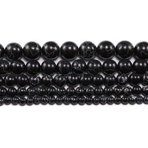 Multiple sizes of polished black round beads with natural white marble patterns