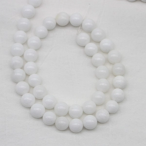 Polished natural white stone round beads arranged in double curves on fabric