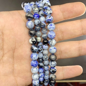 Macro detail of natural agate beads in blue and grey showing polished mineral texture