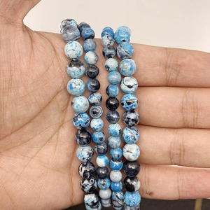 Macro shot of 8mm-10mm round natural blue fire agate beads for jewelry making