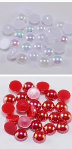 Close-up of flatback half round pearls with iridescent white and metallic red finish