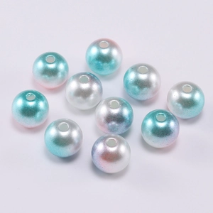 Detailed macro of two-tone gradient candy color ABS faux pearl beads for jewelry DIY