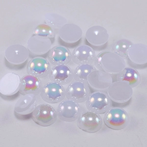 Macro view of white iridescent flatback half pearls for DIY crafts and nail art