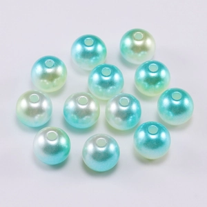 Detail of round ABS faux pearls with light blue and cream gradient for DIY jewelry crafts