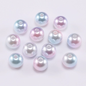 Macro detail of gradient pastel ABS pearl beads with smooth finish and pre-drilled holes