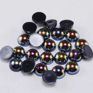 Close-up of iridescent half-round flatback acrylic pearls for DIY jewelry and nail art