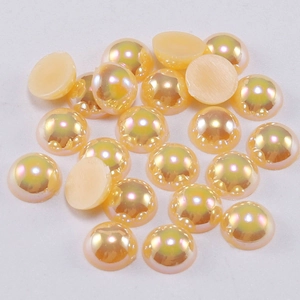 Detailed view of iridescent AB color acrylic flatback half pearls for nail art and DIY