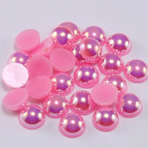 Detailed view of iridescent pink half-round flatback pearls for DIY nail art and fashion
