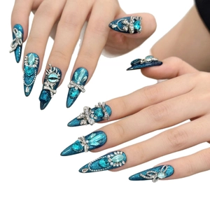 Deep blue stiletto press-on nails with sparkling rhinestones and devil's eye design