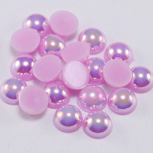 Close-up of pink iridescent flatback faux pearls with AB rainbow coating for DIY crafts