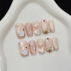 Pink cat-eye press-on nails set with glitter, 3D floral accents and crystal bow details