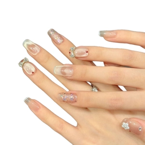 Pink cat-eye press-on nails with silver bows and sparkling 3D floral accents