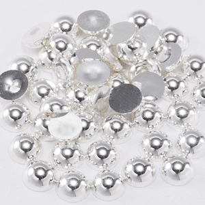 Close-up of silver semi-round flatback pearls with metallic finish for DIY crafts