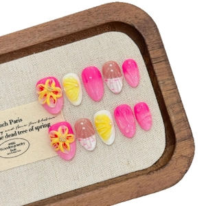 Pink and yellow floral press-on nails with 3D embossed flowers and pearl accents