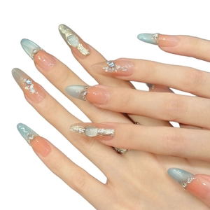 Elegant long pointed press-on nails with blue cat-eye gradient and silver rhinestones