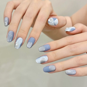 Short glacier blue cat-eye press-on nails with marble texture and pearl accents