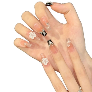 French bow press-on nails with 3D white flowers, pearls and rhinestones on nude base
