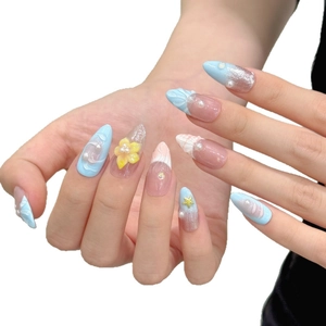 Ocean-themed almond press-on nails with 3D shell, flower and starfish charms on blue gradient