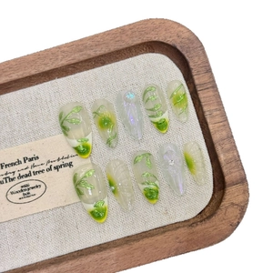Green handmade almond press-on nails with 3D floral carvings and leaf textures