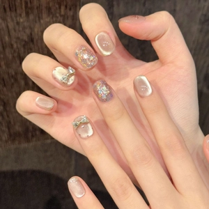 Short square champagne cat eye press-on nails with silver glitter and 3D bow accents