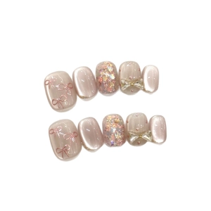 Handmade pink press-on nails set with cat-eye finish and 3D bow charms and glitter
