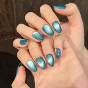 Sparkling cat eye almond press-on nails with blue-green magnetic light effect finish