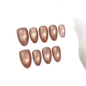 Sparkling almond press-on nails with rose gold cat-eye effect on white background