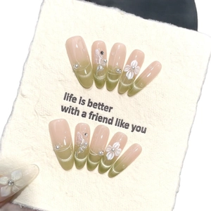 Handmade cat-eye press-on nails with 3D floral designs and pearly green gradients
